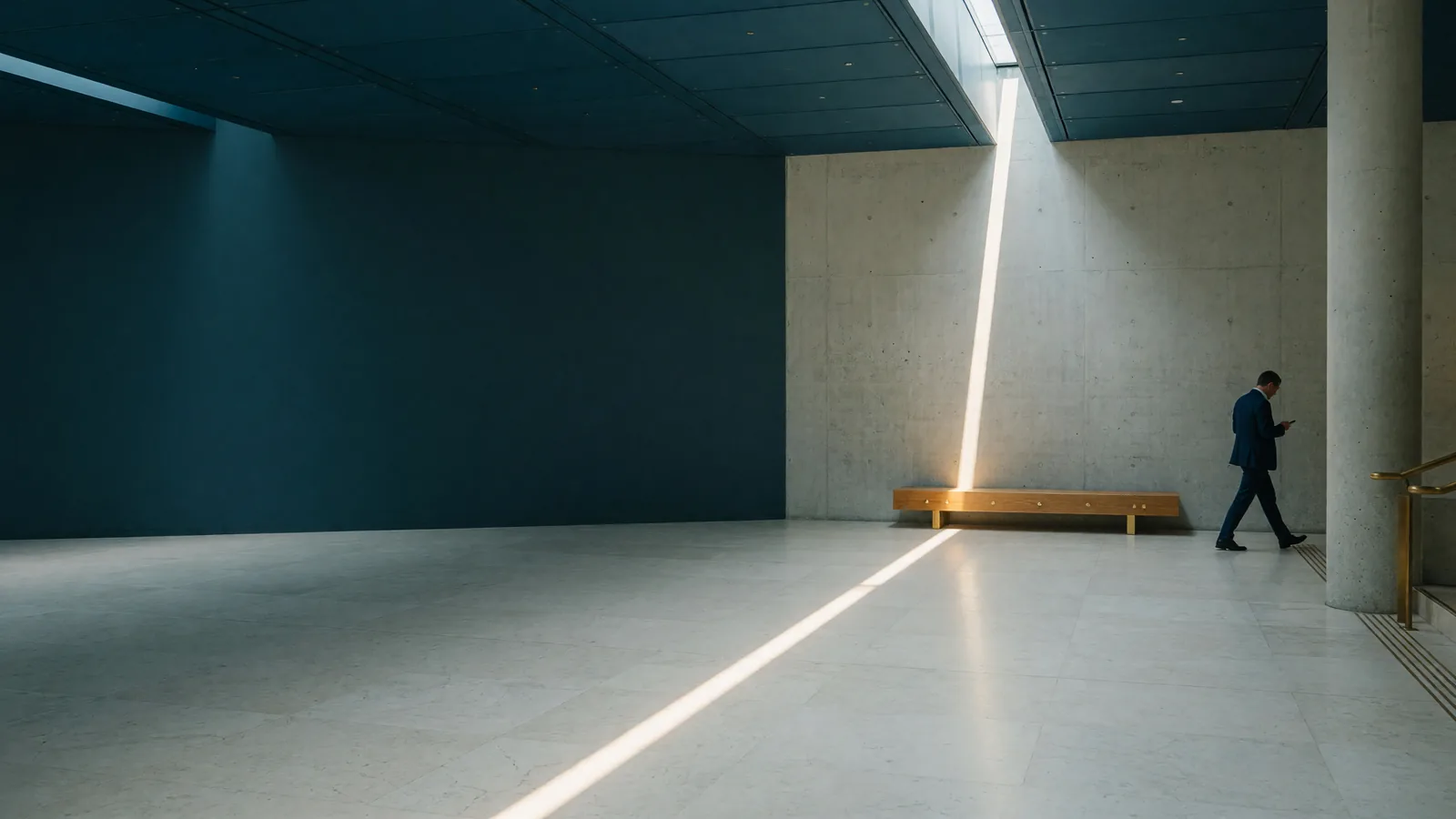 A single line of midday sunlight crossing the stone floor of a quiet atrium
